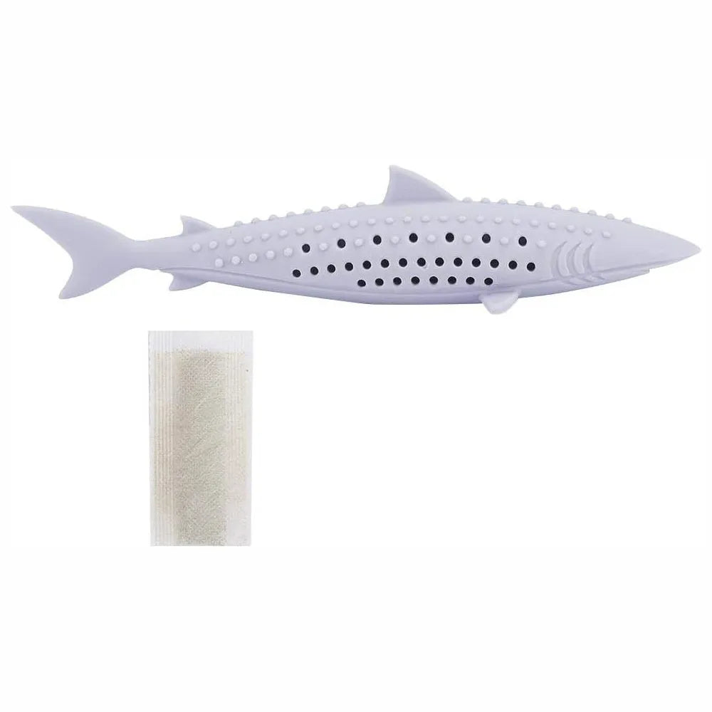 Green fish-shaped silicone cat chew toy with side holes, shown disassembled to reveal hollow interior for catnip.