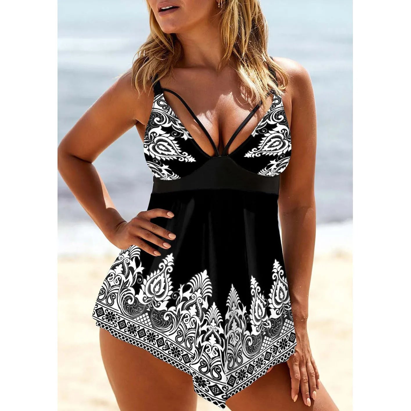 Blue gradient plus size women's swimsuit with deep V-neck, printed straps, and skirted bottom.