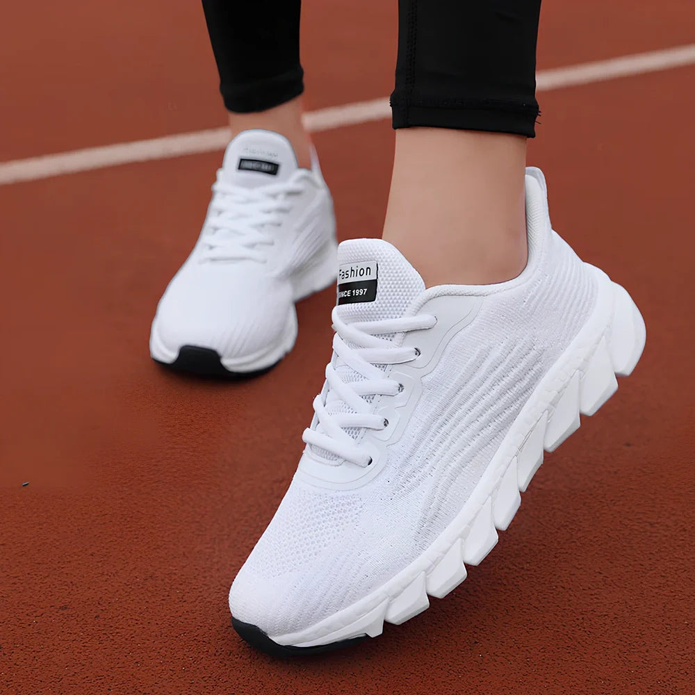 Women's black running sneakers with MD soles and cross strap detailing for jogging