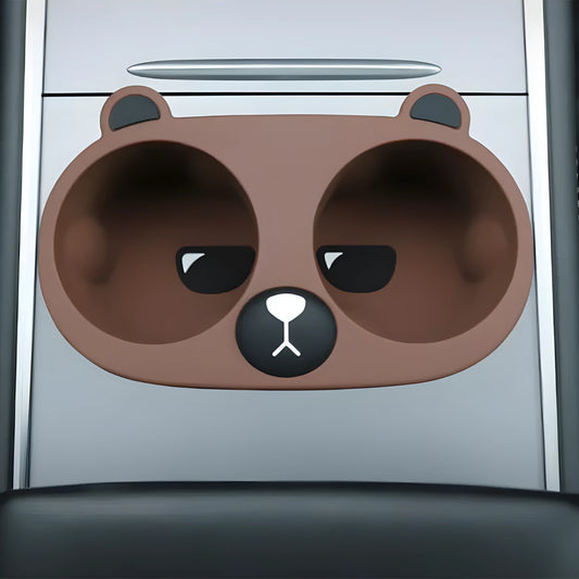 Flexible grey silicone car cup holder insert with a raised cartoon animal design for the centre console.