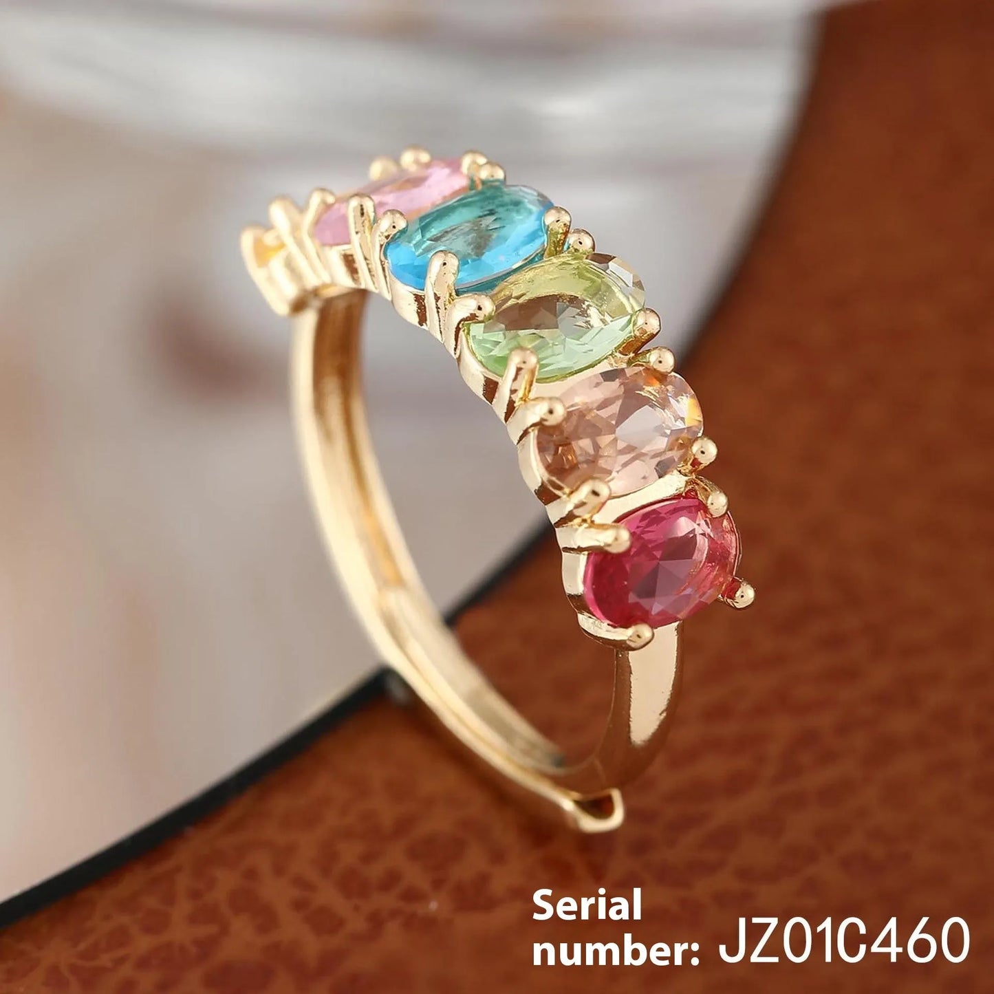 Gold electroplated adjustable open band zircon ring on white background