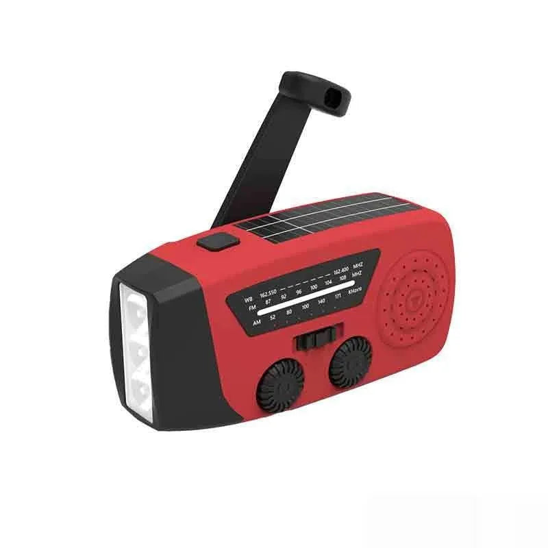 Red rechargeable hand radio with emergency torch, showing compact design with speaker grill and wrist strap attachment