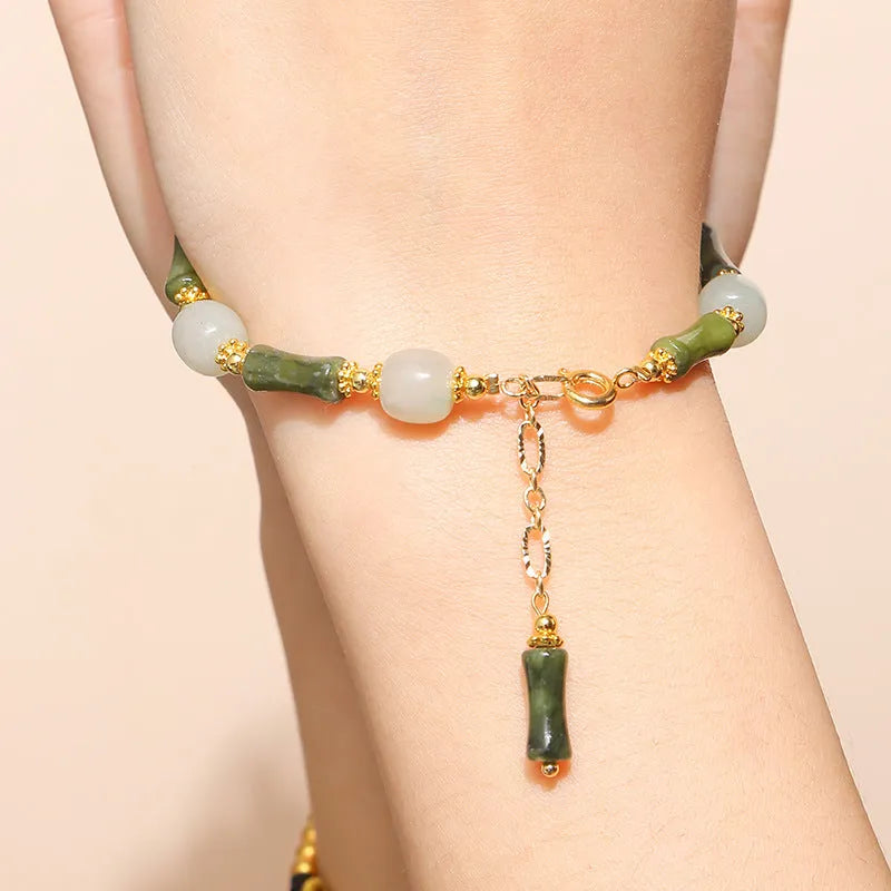 Close-up of a manually crafted crystal agate bracelet with shaped animal and fruit beads.