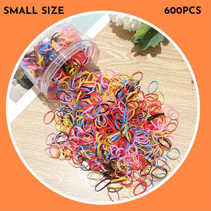 Multicoloured assortment of thin TPU elastic hair bands for babies and children in a reusable plastic container.