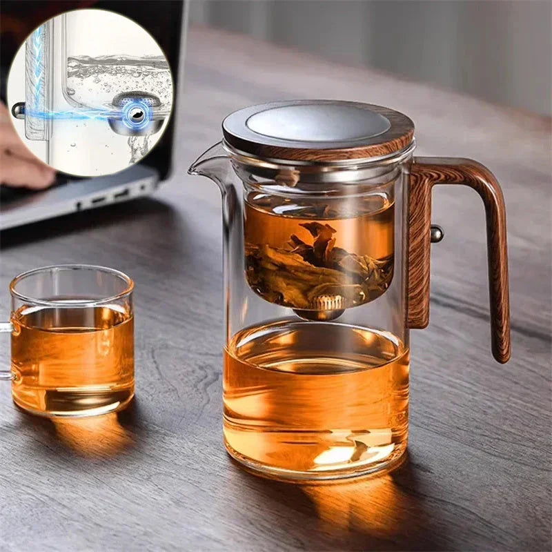 Elegant glass tea infuser pot with magnetic separation technology, wooden handle, and precise pouring spout