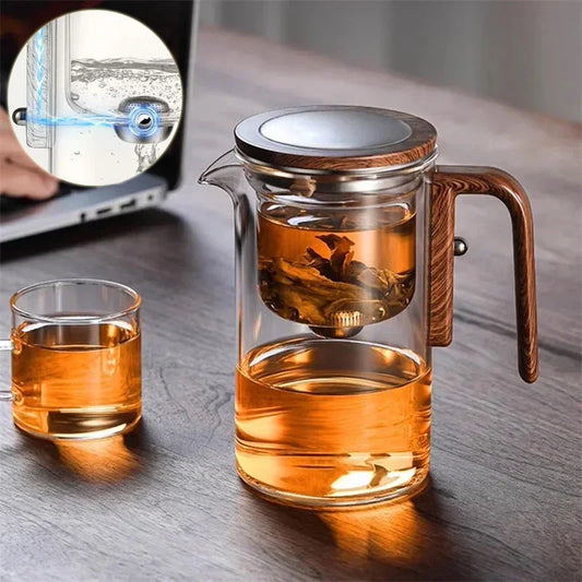 Elegant glass tea infuser pot with magnetic separation technology, wooden handle, and precise pouring spout