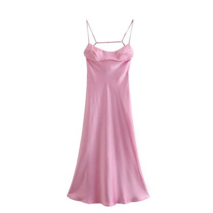 Elegant satin slip dress in pink with a flattering, form-fitting silhouette and sexy backless design