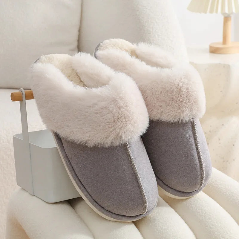 Women's plush indoor slippers in a selection of colours with a fuzzy upper and flat sole.