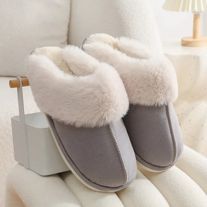 Women's plush indoor slippers in a selection of colours with a fuzzy upper and flat sole.
