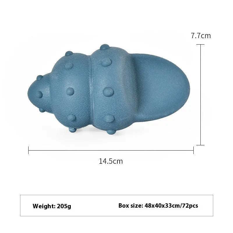 Blue rubber shark-shaped dog toy with food dispensing openings on a white background.