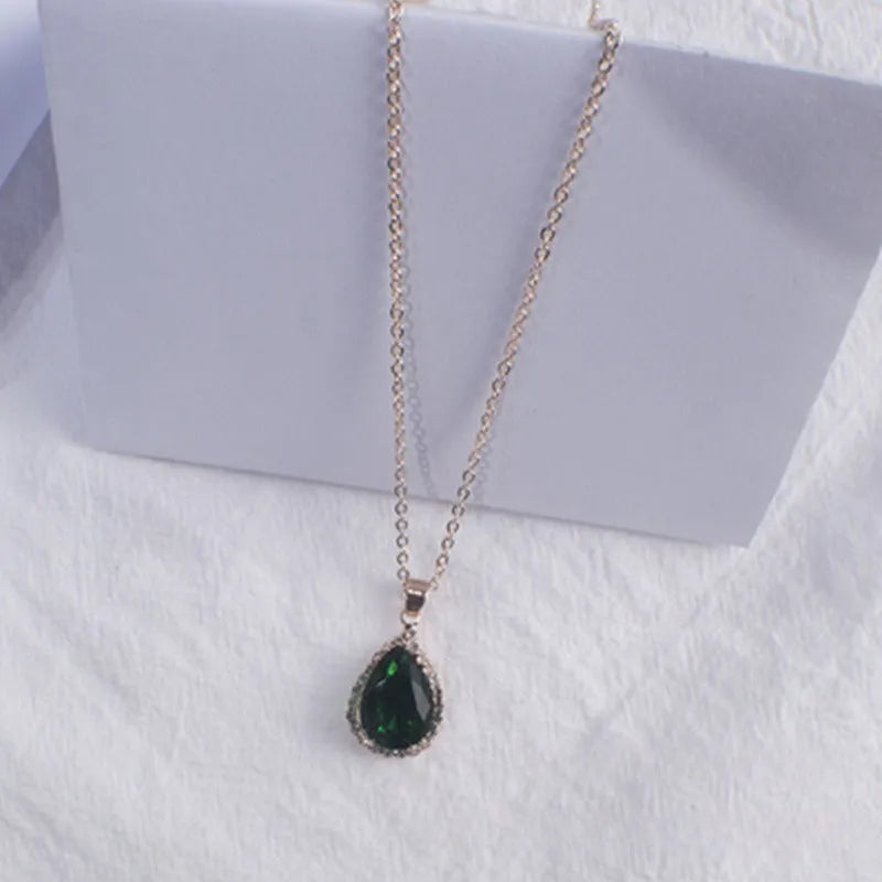 Rose gold geometric water drop pendant necklace on a model, showing adjustable chain and sparkling stone inlay.