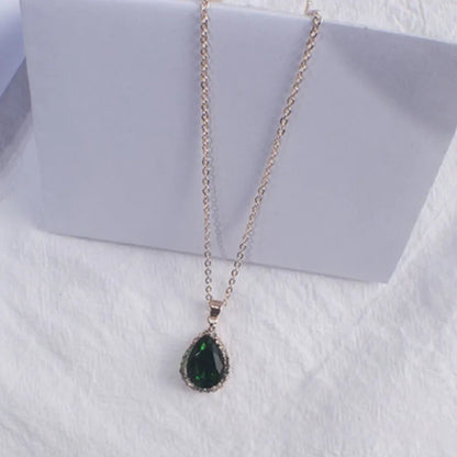 Rose gold geometric water drop pendant necklace on a model, showing adjustable chain and sparkling stone inlay.