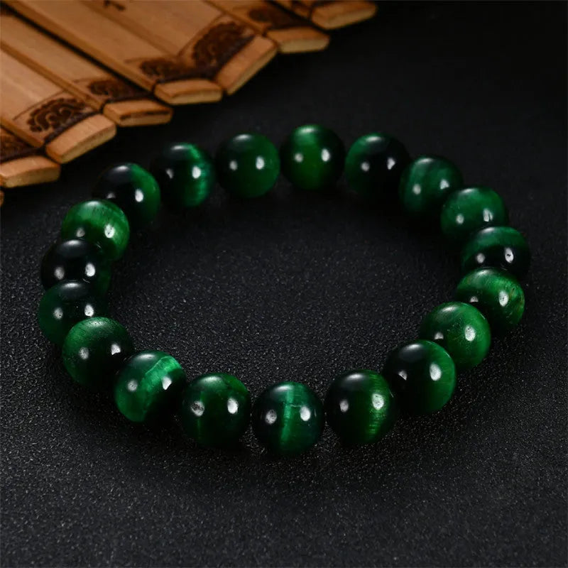 Green Tiger Eye stone bracelet with geometric beads, showing size options.