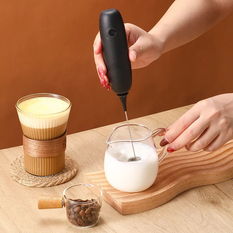 Hand-held electric milk frother in black or white colour, modern design for frothing and blending beverages