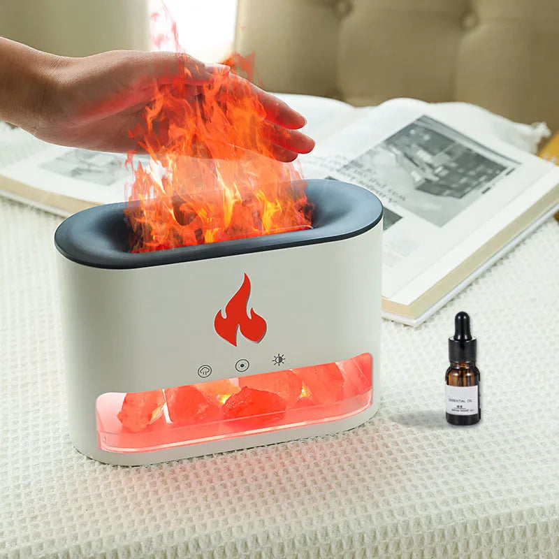 White square flame humidifier with colourful 3D light effect and crystal salt stone on a desk.
