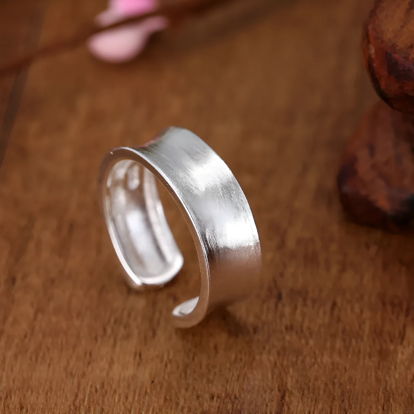 Geometric open sterling silver ring with frosted finish and adjustable gap.