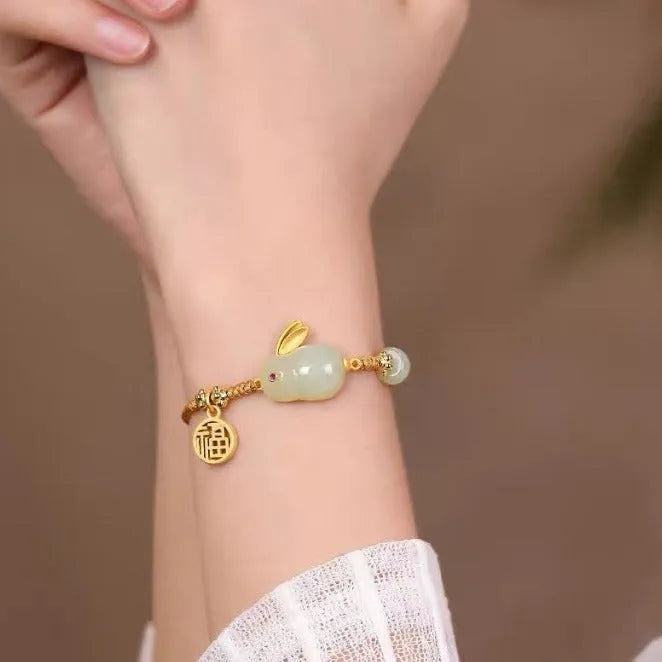 Hetian jade geometric rabbit charm on a yellow string bracelet for women.