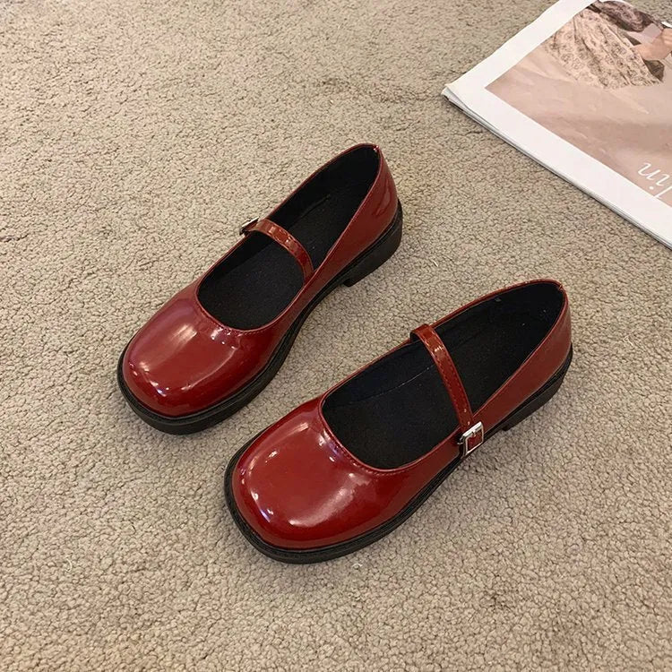Women's solid colour French vintage leather shoes with round toe and flat heel design in red, black, and grey options