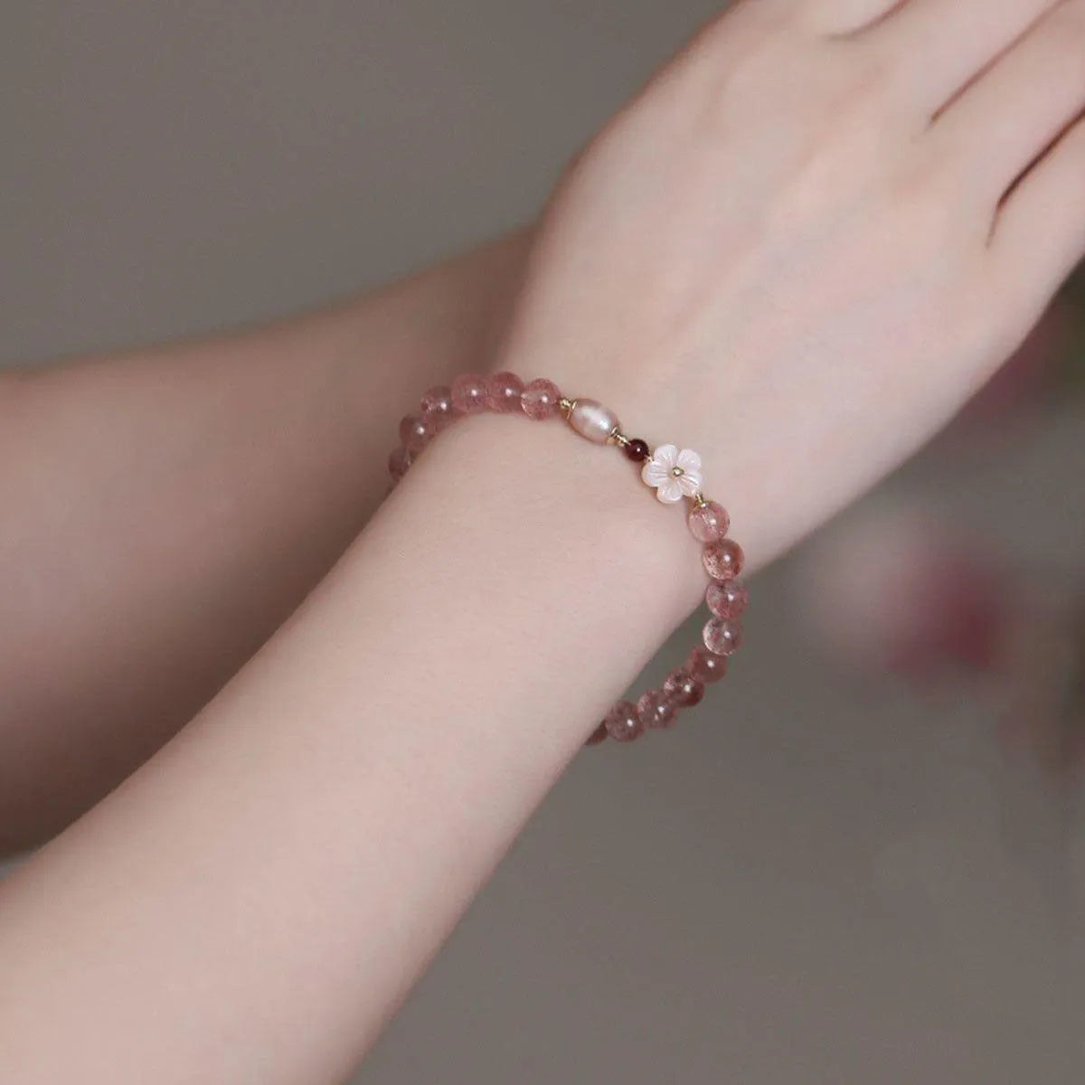 Strawberry quartz peach blossom crystal bracelet for women showing floral design.