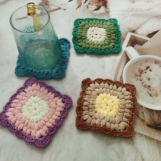 Crocheted wool cup coaster with grandmother lattice pattern in selected colour