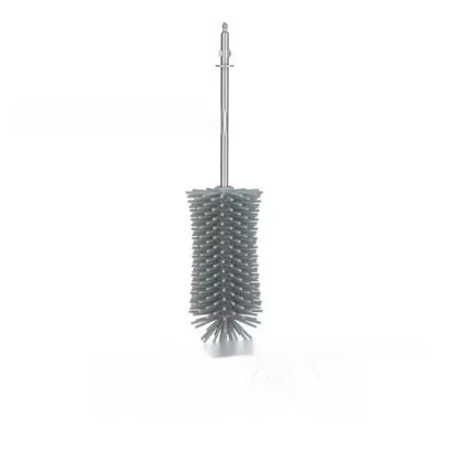 Green electric cleaning brush with scouring pad and brush heads on a kitchen worktop.