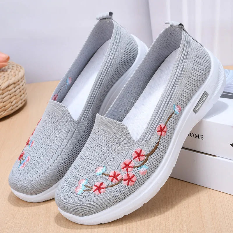 Women's low-top embroidered fly knit sports pumps in wine red with anti-slip sole.