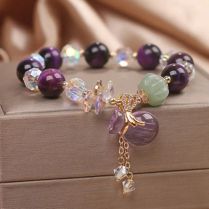 Women's forest style crystal bracelet with purple tigereye money bag pendant and rhinestone details