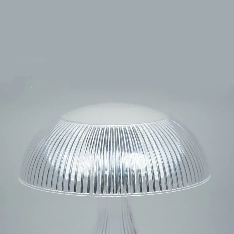 USB rechargeable acrylic table lamp with three colour changing modes on a surface.