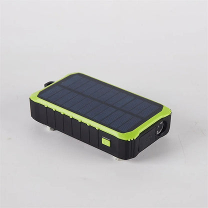 Orange and green hand solar power bank with solar panel, USB ports, and LED light showing 12000mAh capacity