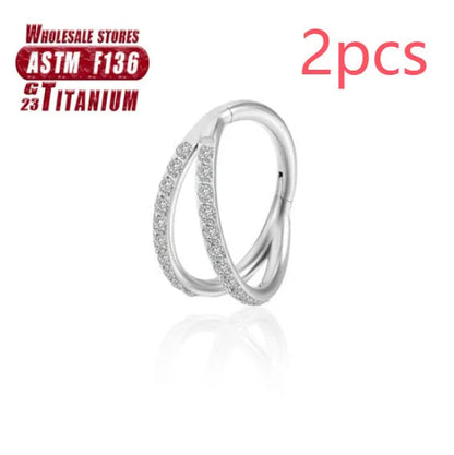 Pair of titanium alloy nose rings on a plain background showing silver, gold, black, and rose gold colour options.