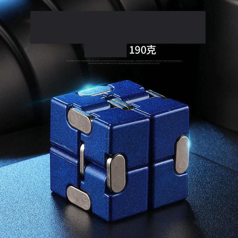 Zinc alloy Infinity Cube with eight rotating cubes showing black and silver colour options on wooden surface