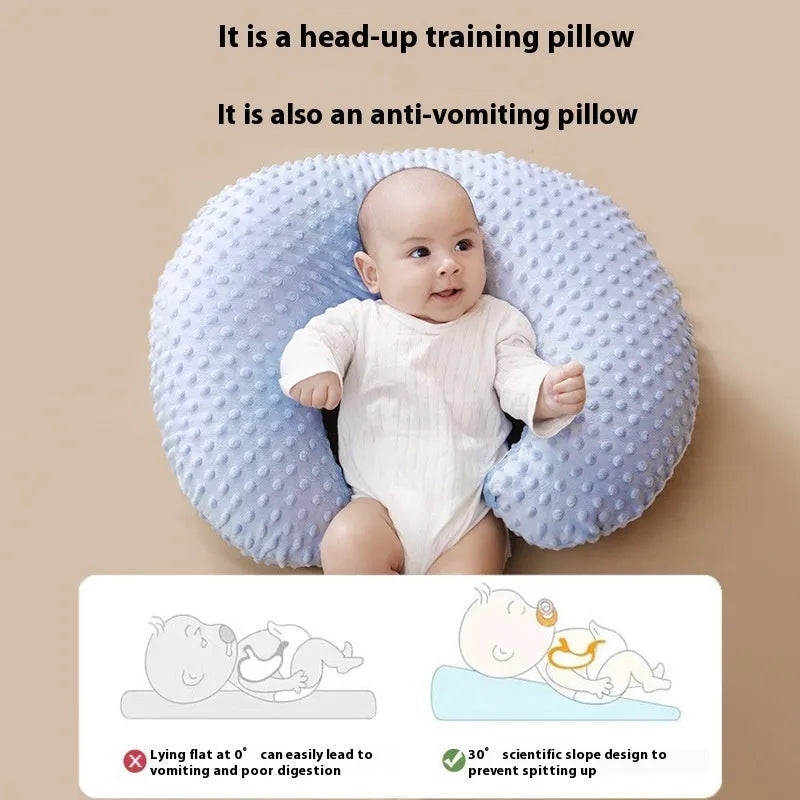 Nursing pillow with integrated 15cm raised barrier to prevent milk spills during breastfeeding, shown with removable pillowcase