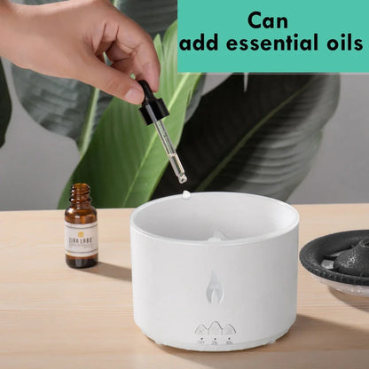 Black columnar ultrasonic humidifier producing jellyfish smoke rings with flame lighting effect