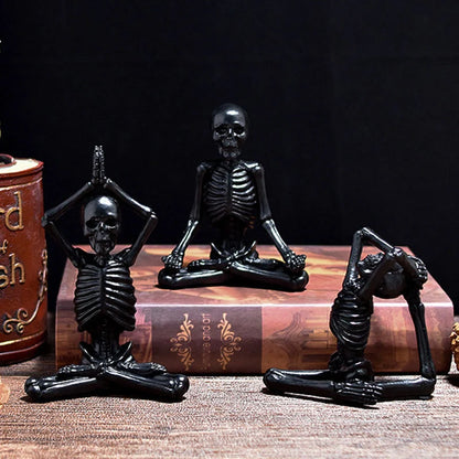 Spooky skeleton desktop decorations featuring intricate resin skulls and skeletons in vintage white and ominous black color options
