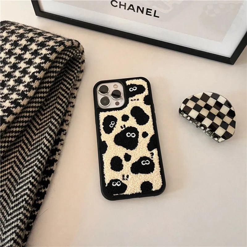 Black plush fairy character back cover case for Apple iPhone mobile phone.
