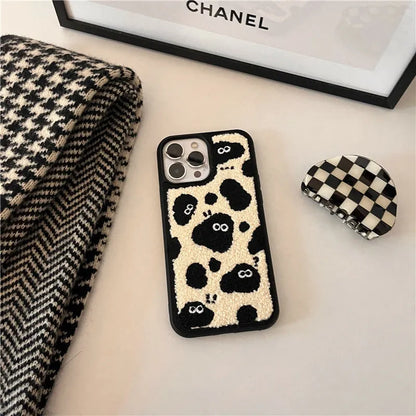 Black plush fairy character back cover case for Apple iPhone mobile phone.