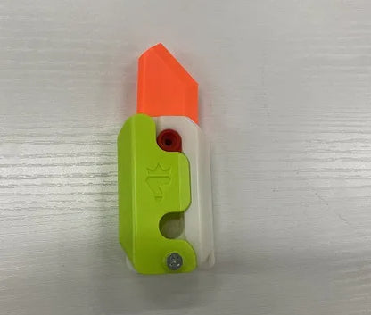 Small orange and green 3D printed plastic carrot knife fidget toy with blade extended.