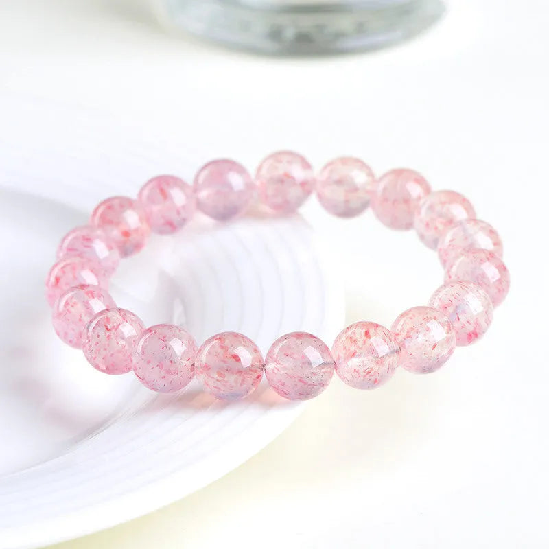 Strawberry Quartz bracelet with 10-10.8mm faceted crystal beads on stretch cord, a natural white water crystal ball beaded bracelet for unisex healing and chakra energy work.