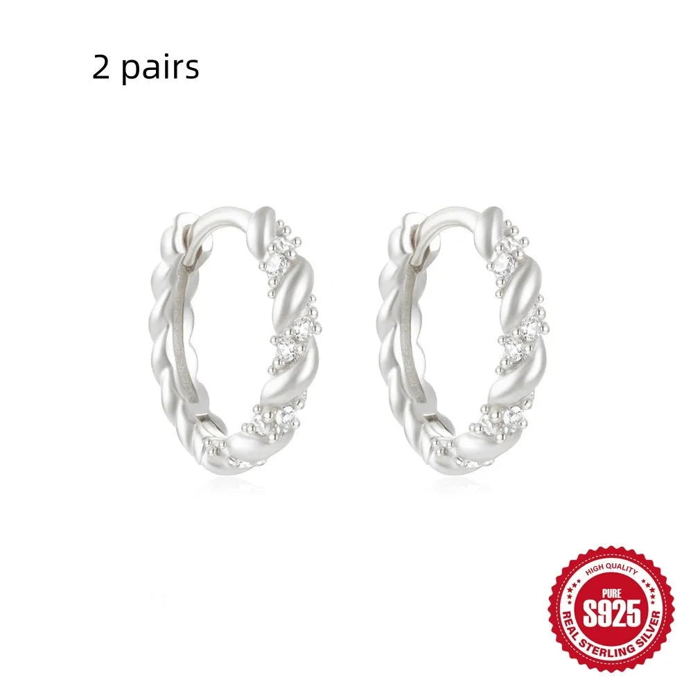 Sterling silver geometric stud earrings with small round diamond accents in gold or silver finish