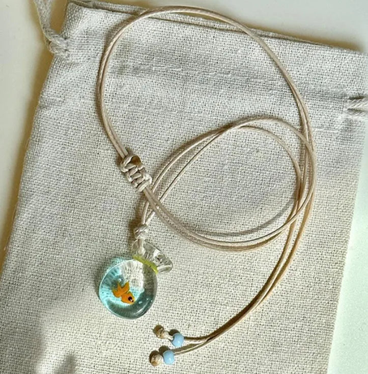 Women's necklace with coloured glaze pendant on a cotton-linen chain, showcasing world-style design