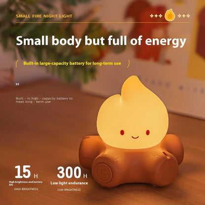 Small silicone fire pile-shaped night lamp with a cartoon ABS shade showing yellow light illumination.