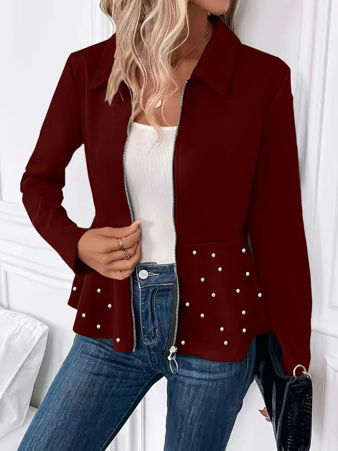 Women's black coat with heavy-duty zipper and ruffled hem detail in loose-fitting silhouette