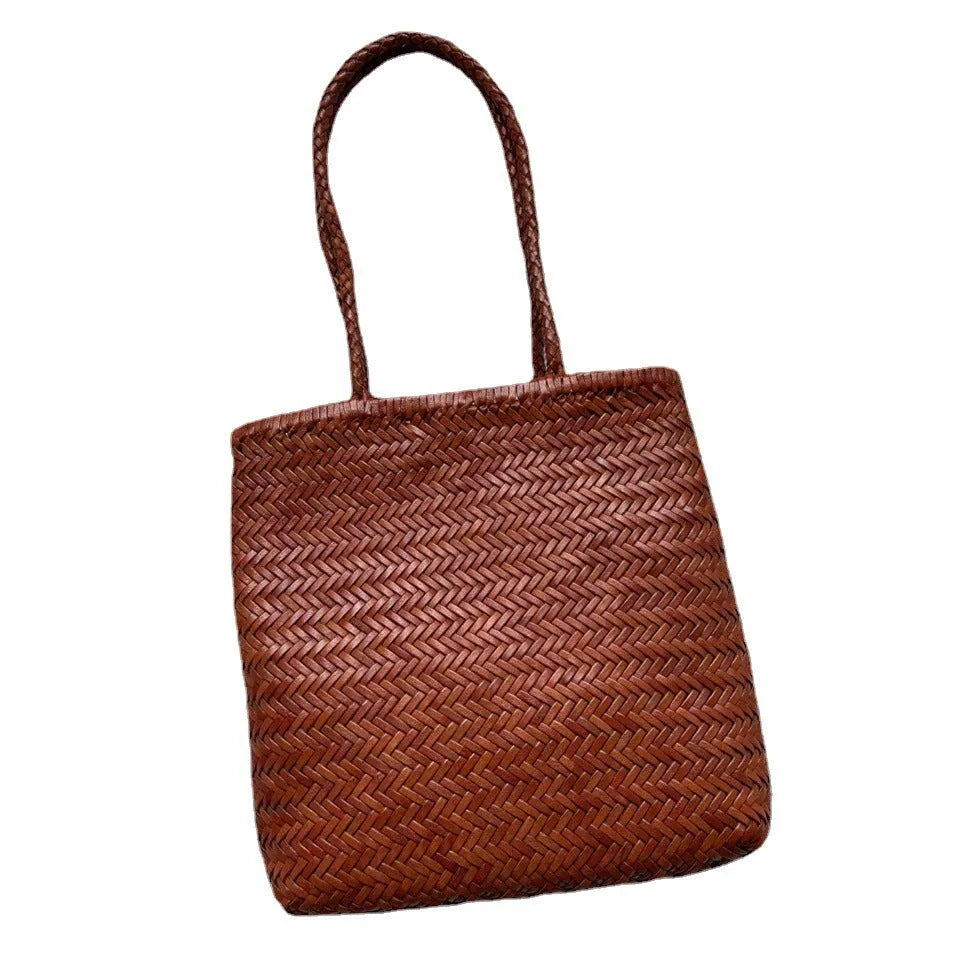 Brown woven cowhide leather tote bag with three-dimensional pocket, shown with dimensions 27cm by 30cm