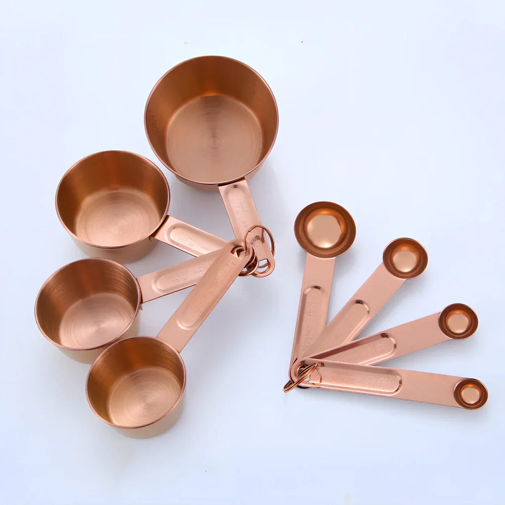 Stainless steel measuring spoons and cups set with engraved markings and removable storage rings