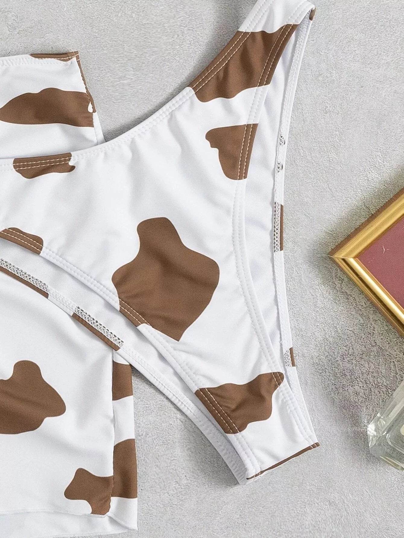 Women's cow print sleeveless swimsuit in coffee color, sizes S to 2XL