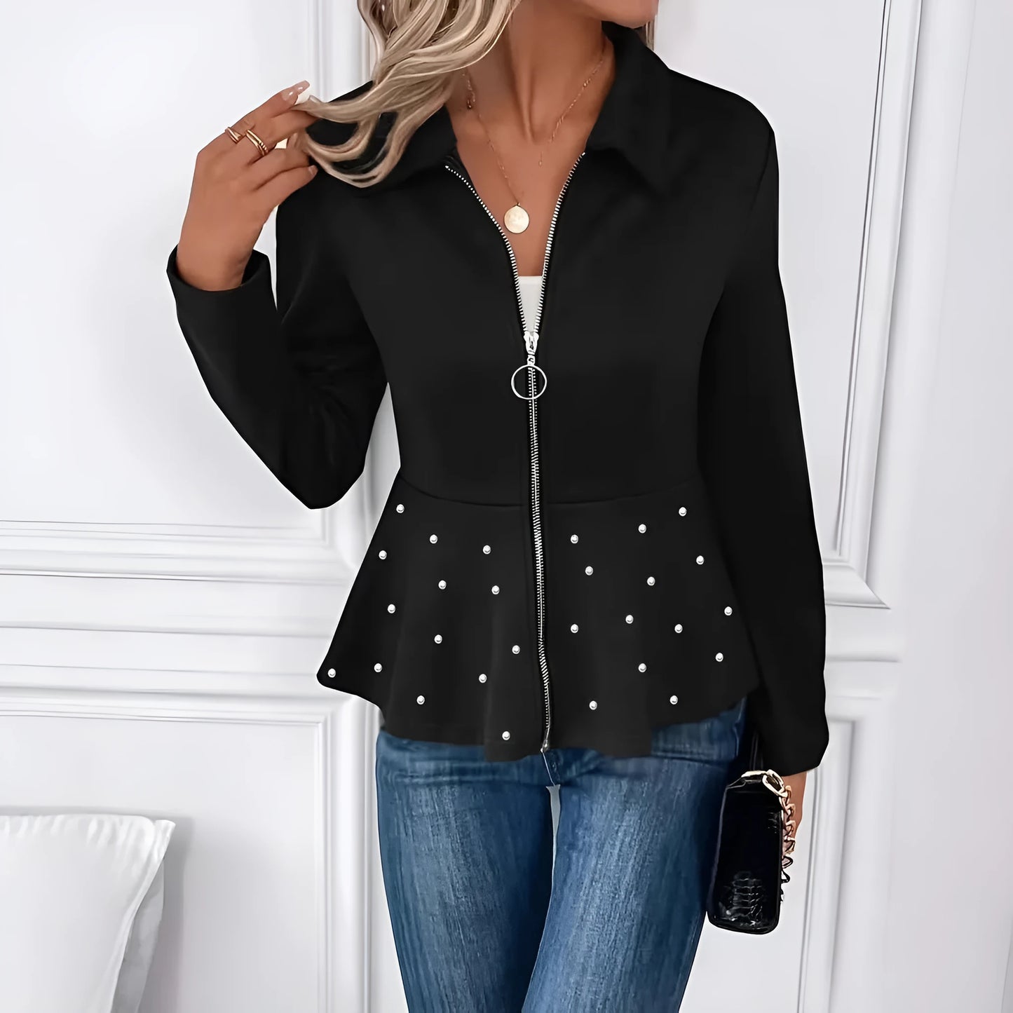 Women's black coat with heavy-duty zipper and ruffled hem detail in loose-fitting silhouette