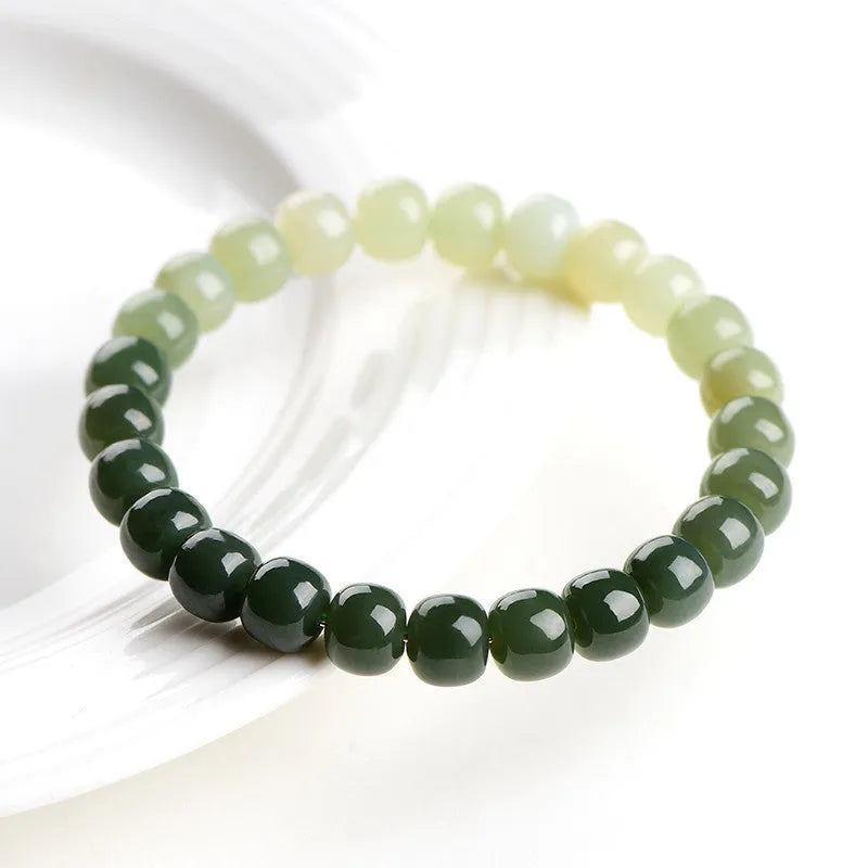 Natural Hetian jade bracelet showing gradient clear water colour on polished beads with either 6x7mm or 7x8mm dimensions