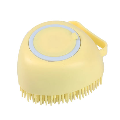 Blue silicone dog bath and massage brush held in a hand.