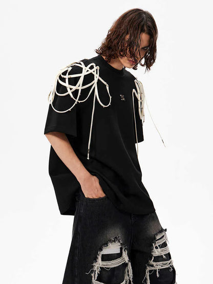 Black loose fit short sleeve t-shirt with padded shoulder detail on a hanger.