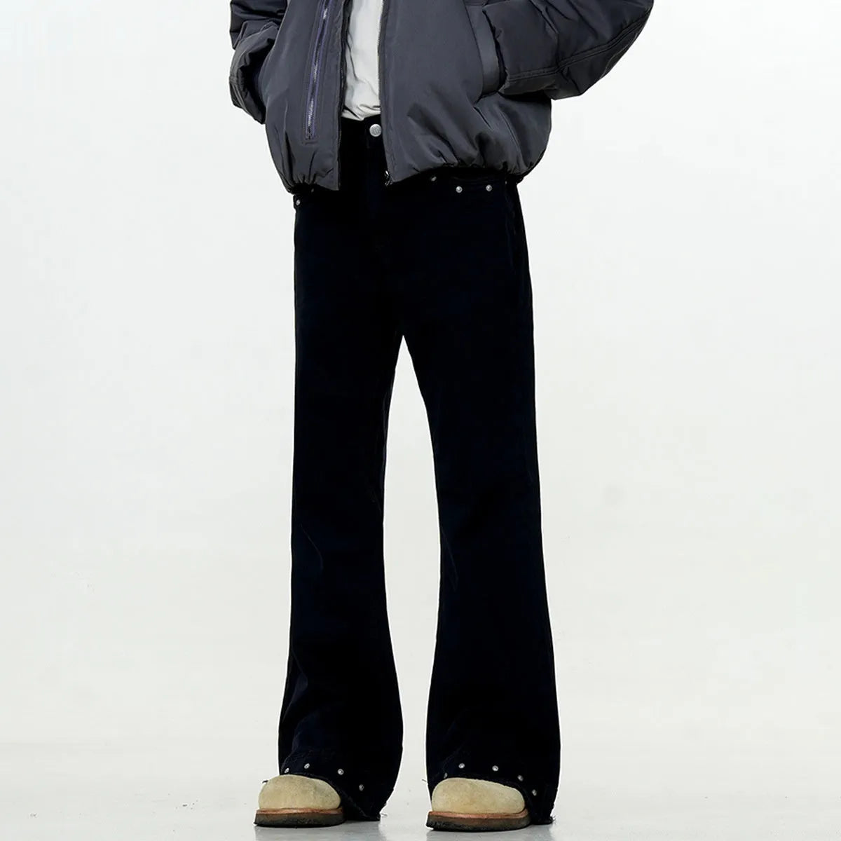 Pair of black straight-leg skinny jeans with a mid-rise waist and zipper fly on a neutral background.